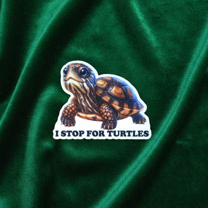 Sticker of a turtle with 'I Stop for Turtles' text on green fabric