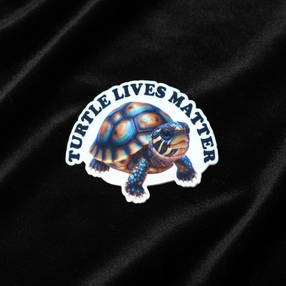 Sticker with a turtle design and 'Turtle Lives Matter' text on black fabric