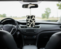 Car interior with a black & White cow print air freshener hanging from the rearview mirror.