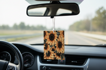 Sunflower-patterned car air freshener hanging from a car's rearview mirror.